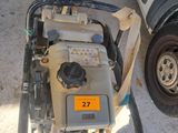 a small generator on the ground next to a car