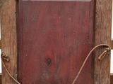 an old wooden frame with a rope hanging from it ' s sides