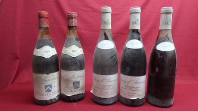six bottles of wine are lined up on a red background