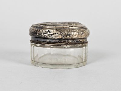 an image of a glass jar with a silver lid on a white surface