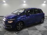 a blue citrole parked on a checkered floor in a garage