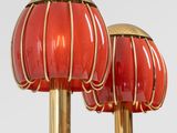 pair of red and gold table lamps on a white surface