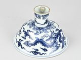 a blue and white vase with a dragon on it