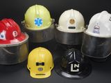 six hard hats are lined up in a row on a black background
