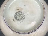 a white bowl with a blue stripe around the rim