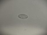 a close up of a silver plate with a name on it