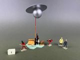a group of toy figurines that are playing with an object