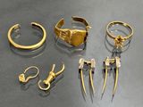 a lot of gold jewelry on display on a table