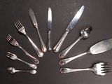 several forks and spoons are arranged in a circle on a table