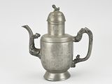 an old silver teapot with a handle and a lid
