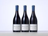 three bottles of wine sitting on top of a table next to each other