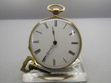 a gold clock with roman numerals on the face