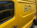 a yellow van parked in front of a building