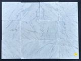 a white marble tile with a yellow dot in the middle