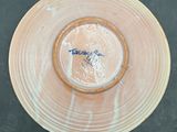 a brown plate with a blue and white design on it