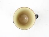 overhead view of a coffee cup on a white surface