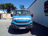 a blue truck that is parked in front of a building