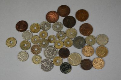 a pile of coins on a table with a white background