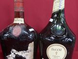 three bottles of liquor sitting next to each other on a red surface