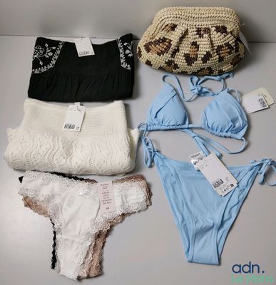 a lot of women ' s underwear and a purse on a table