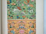 an open book with a picture of flowers and birds on a green background