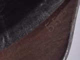 someone is wearing a black hat and has a brown belt