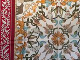 a picture of a red and white cloth with a picture of animals on it