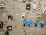a large display of electronics on the wall in a store