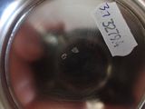a person holding a silver cup with a sticker on it