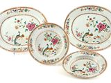 four pieces of chinese porcelain dishes with floral designs on them