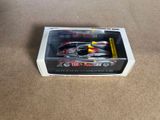 a toy car that is in a box on the floor