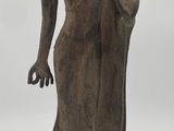 statue of a standing buddha on a wooden base on a white background
