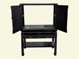 a black cabinet with a mirror on top of it