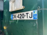 a close up of a sign on the side of a green building