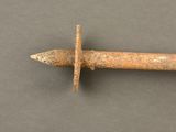 a close up of a rusted iron nail on a gray surface