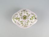 underside view of a green and white porcelain bowl with a floral design