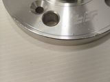a close up of a stainless steel flange on a table