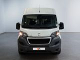 the front of a white van is parked in a white room