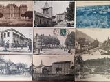 several old postcards of old buildings on a wooden table