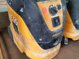 two yellow and black vacuum cleaners sitting on the floor