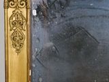 a mirror with a gold frame on the wall