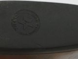 a person holding a pair of black shoes in their hand