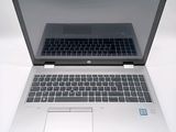 a laptop that is open on a white surface