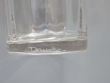 a clear glass with a small amount of water in it