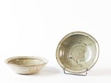 two bowls sitting next to each other on a white surface
