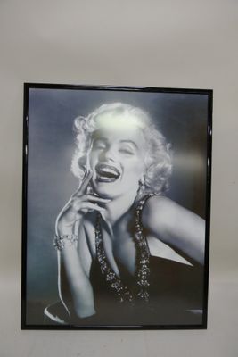 framed black and white photograph of marilyn monroe laughing and holding her hand to her mouth