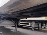 underside of a semi truck parked on the side of the road