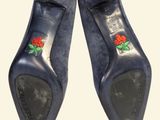 two pairs of blue shoes with red roses on them