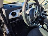 the interior of a small car with a steering wheel and dashboard