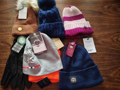 several hats and gloves are laid out on a table